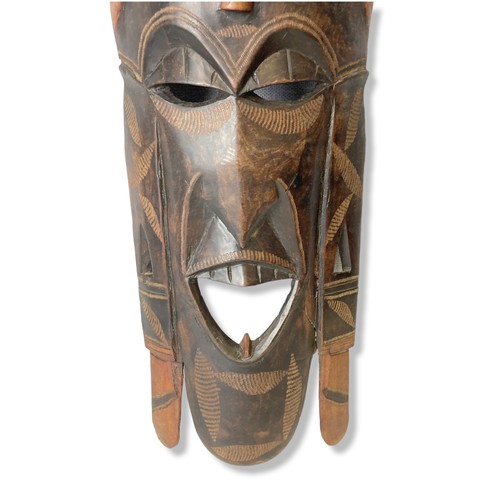 349 - A large carved wooden African tribal mask. 
58cm tall