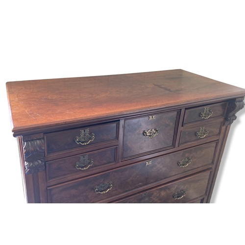 314 - A 19th-Century Mahogany Scotch Chest of Drawers. With carved finials. Square central drawer bordered... 