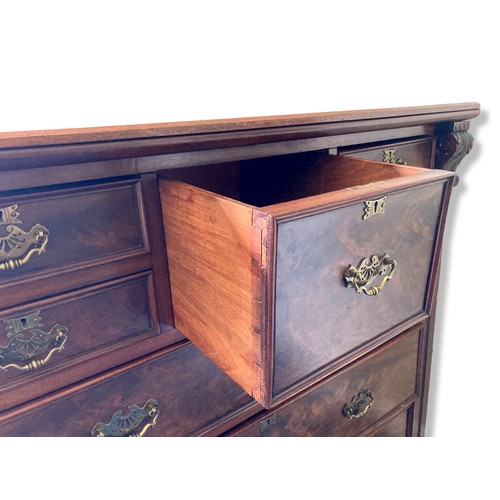 314 - A 19th-Century Mahogany Scotch Chest of Drawers. With carved finials. Square central drawer bordered... 