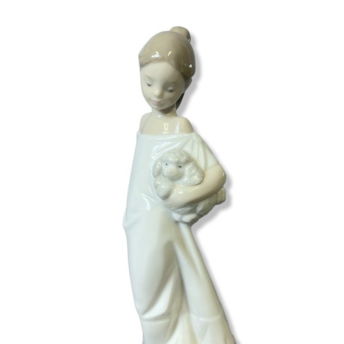 171 - A Lladro porcelain figurine together with a Nao example.
lladro figure stands - 27cm