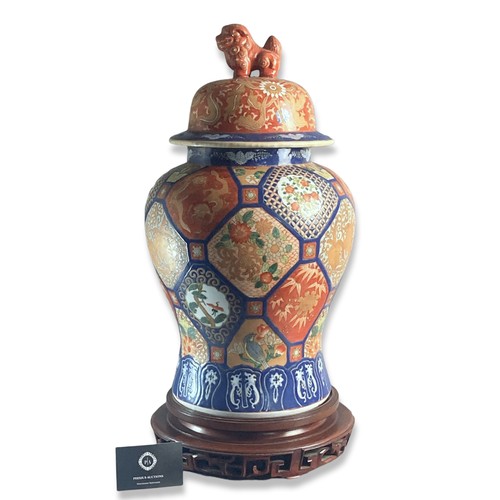 109 - Large hand painted Japanese Imari vase & cover.
On carved wooden base.
Signed to base.