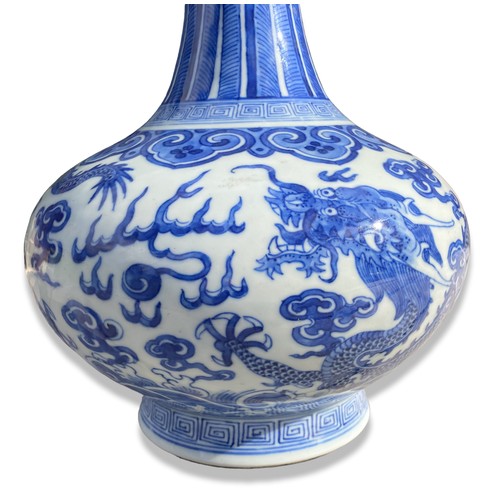 238 - A Chinese Qing porcelain vase. Depicting Two 5-claw Dragons Chasing a Pearl amongst clouds and above... 