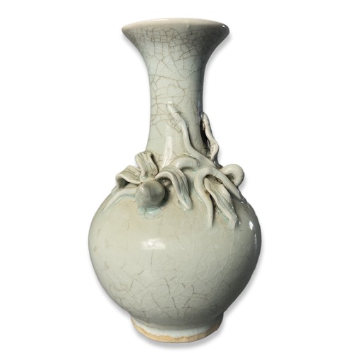 258 - A Chinese Longquan Celadon porcelain vase. Relief decorated bud on crackle ground.
22cm Tall