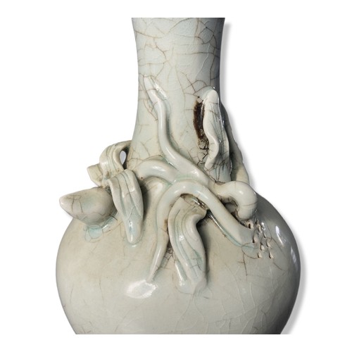 258 - A Chinese Longquan Celadon porcelain vase. Relief decorated bud on crackle ground.
22cm Tall