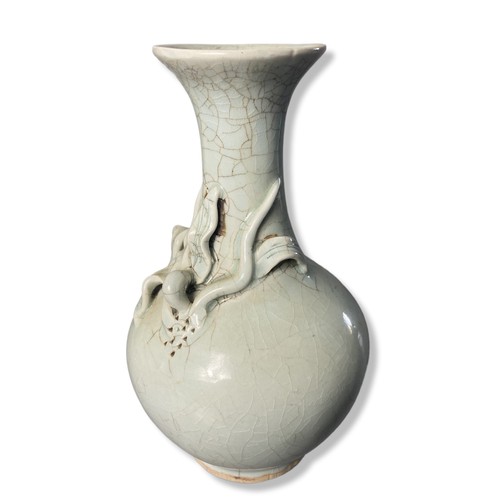 258 - A Chinese Longquan Celadon porcelain vase. Relief decorated bud on crackle ground.
22cm Tall