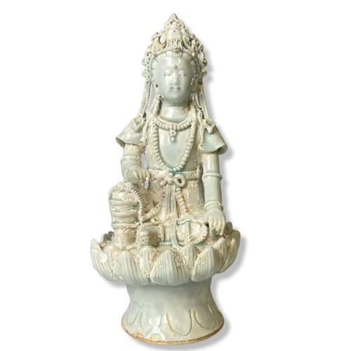 264 - A Chinese Qingbai Celadon porcelain Guanyin. Seated on a Lotus throne. Adorned with beaded jewellery... 