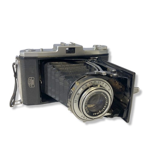 72 - Three vintage folding cameras, including a Nettar Velio, A telma Zeiss Ikon and a Kodak folding Brow... 