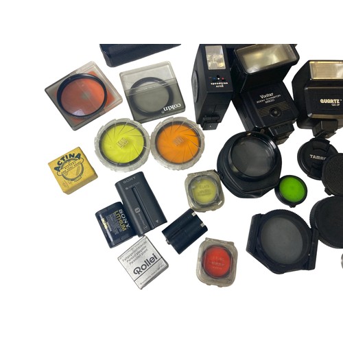 96 - A collection vintage Photography equipment. Includes Lens cases, flashes, Filters, winder, lens hood... 