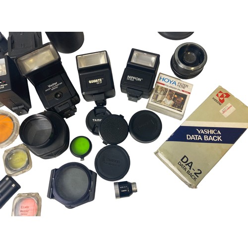 96 - A collection vintage Photography equipment. Includes Lens cases, flashes, Filters, winder, lens hood... 