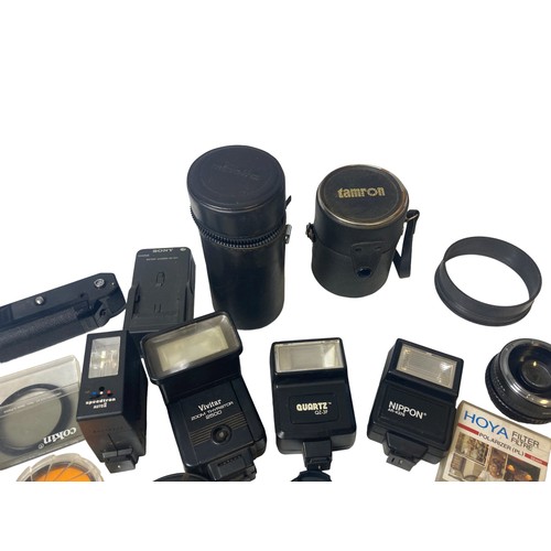 96 - A collection vintage Photography equipment. Includes Lens cases, flashes, Filters, winder, lens hood... 