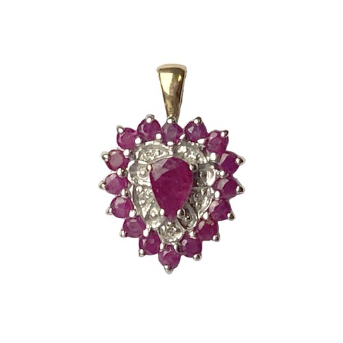 24 - A 9CT Gold, Ruby & Diamond pendant. With a central Pear cut Ruby with 16 surround Rubies and accent ... 