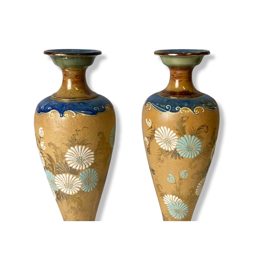 124 - A pair of Royal Doulton stoneware Slaters vases, together with another similar. 
31cm Tall.