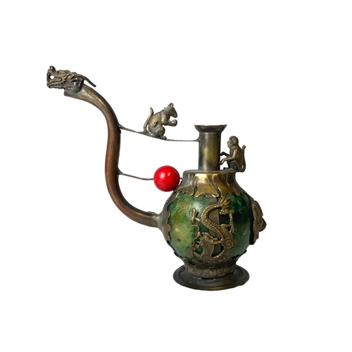 64 - A collection of Oriental metal items, including a Tibetan metal & Jade opium pipe and Dragon mounted... 