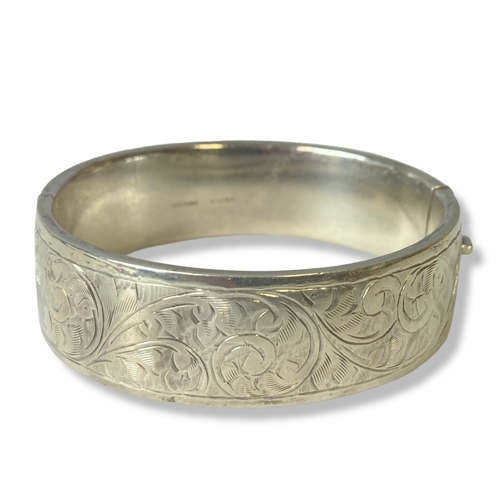 19 - An engraved sterling silver bangle together with various Silver & white metal lockets, pendants etc.