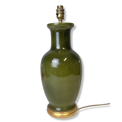 169 - A Chinese type green glaze table lamp. On gilt stand.
42cm tall