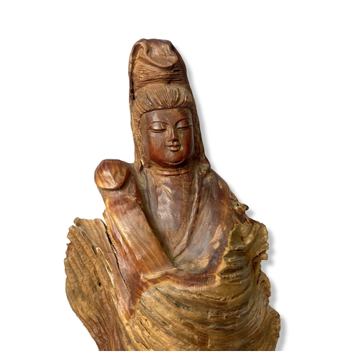 106 - A Chinese naturalistic Carved wood root Guanyin.
33cm tall.