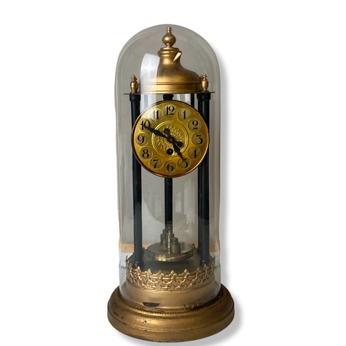 194 - A Glass domed Torsion Anniversary Bandstand clock. With Disc pendulum.
38cm Tall.