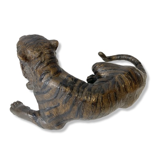 161 - A Bronze sculpture of a recumbent Tiger. 
33 x 15 cm