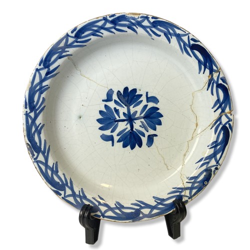 138 - An 18th-century Delft ware plate. Central floral motif with similar border pattern.  Repaired.
22cm ... 