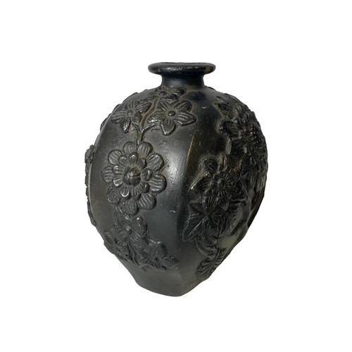 68C - A pair of metal Buddha figures on wooden base. Together with a relief decorated black pottery vase. ... 