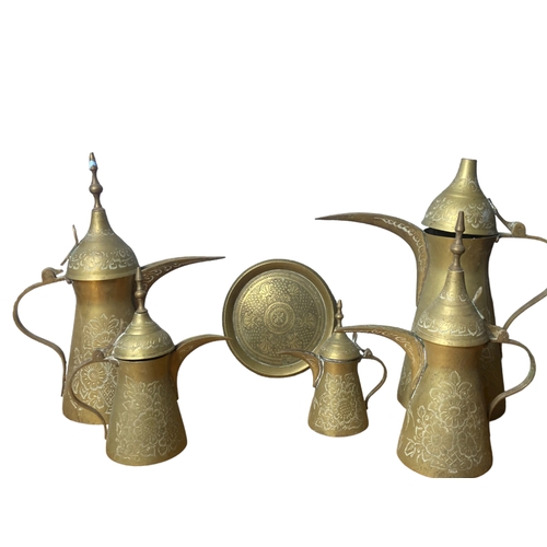 45 - A collection of engraved Arabic Brass Dallah coffee pots and dish.