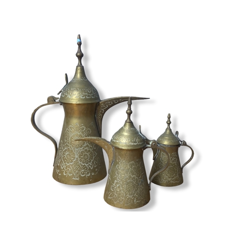 45 - A collection of engraved Arabic Brass Dallah coffee pots and dish.