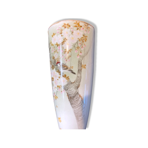 97 - A Japanese Celadon porcelain wall pocket. Meiji period. Painted with birds amongst cherry blossoms.