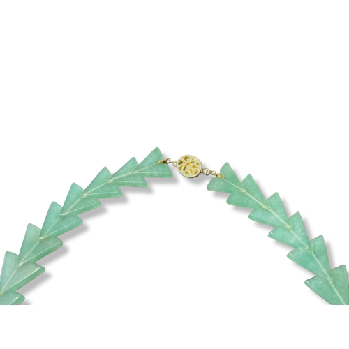 25 - A Chinese Jade Arrowhead necklace.