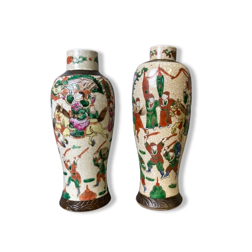 148 - Two Chinese porcelain baluster vases. Crackle ground with over-glaze enamel battle scenes. Late Qing... 