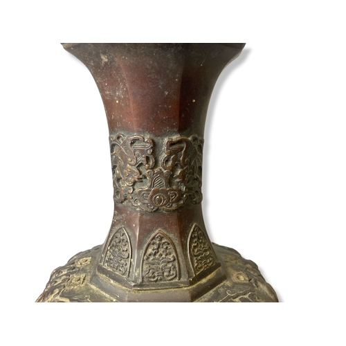 144 - A 19th-century Japanese Bronze vase. Raised on greek-key feet, with relief decorated Dragons & Phoen... 