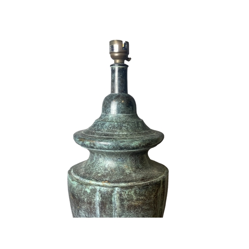 196 - A Bronzed cast iron table lamp. Classical shape.