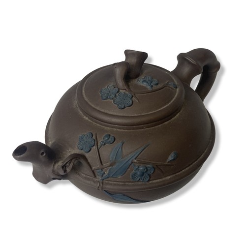 59 - A Chinese Yixing pottery teapot. With painted relief decorated flowers. Signed to base.
8 x 17cm