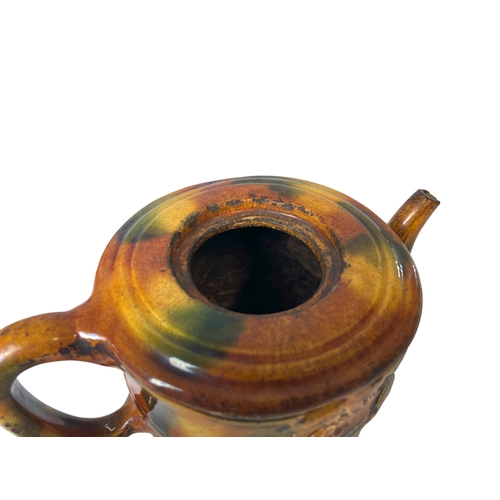 168 - An early Chinese or Japanese glazed pottery teapot.
9 x 17 cm