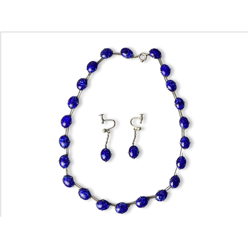 7 - A Sterling silver and Lapis lazuli necklace and earring set. 
Polished lapis lazuli inset in silver ... 