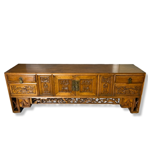 166 - A Chinese carved Elm Meditation / Altar table.
With carved hand-panelled doors and drawers depicting... 