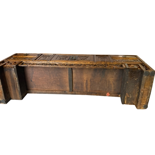 166 - A Chinese carved Elm Meditation / Altar table.
With carved hand-panelled doors and drawers depicting... 