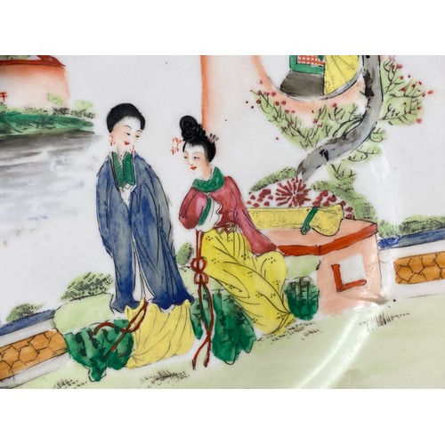 182 - A Chinese porcelain Famille rose dish. Depicting two woman in a courtyard scene. 
23cm Diameter