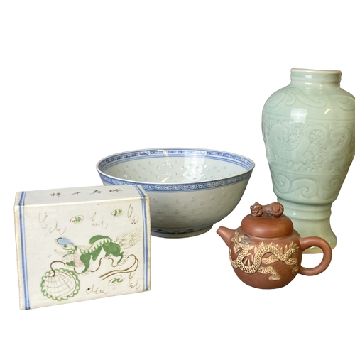 180B - A collection of Chinese porcelain. Including a Celadon vase, Opium pillow, Yixing teapot and rice pa... 