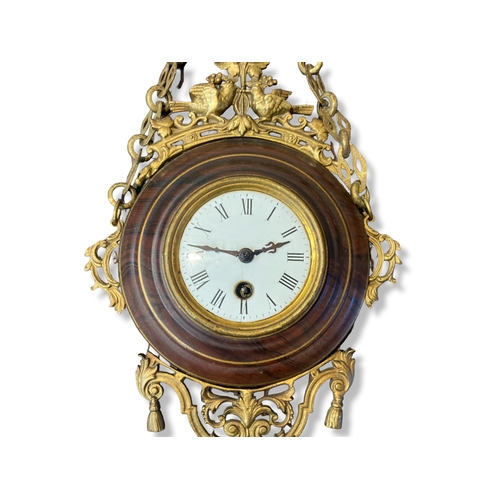 166 - A French Gilt metal hanging wall clock. With faux wood effect surround.  White Enamel face with Roma... 