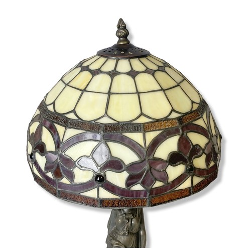 184 - A bronzed metal Tiffany style table lamp. Base in classical lady form. 
55cm tall