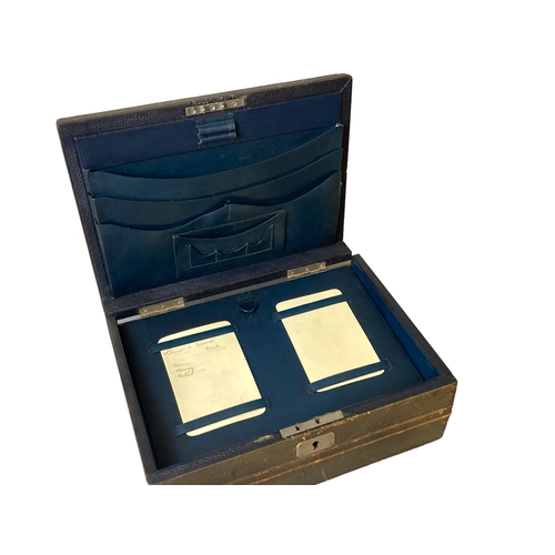 206 - An early 20th-century leather bound writing slope / stationery box. With fitted leather & wooden int... 