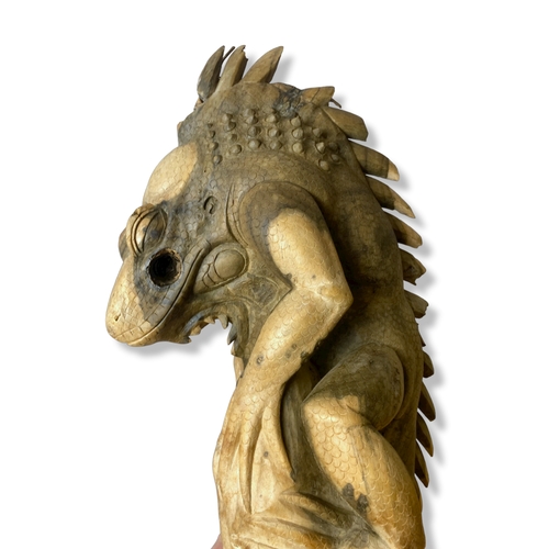 208 - A large carved wooden Iguana ornament.