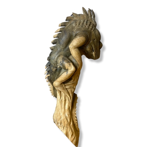 208 - A large carved wooden Iguana ornament.