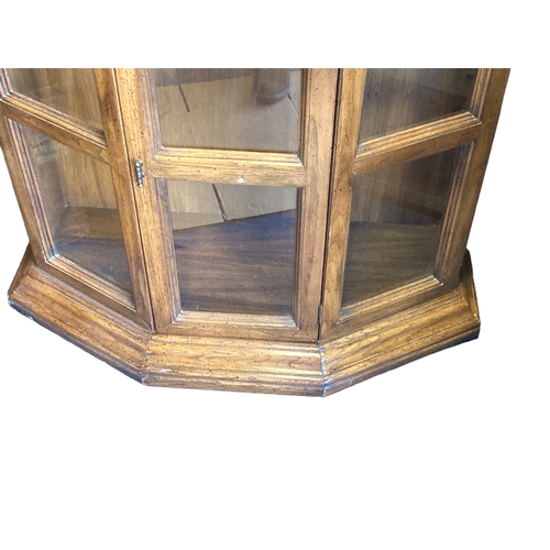 210 - A glazed glass Display cabinet. With two opening doors and interior shelves.