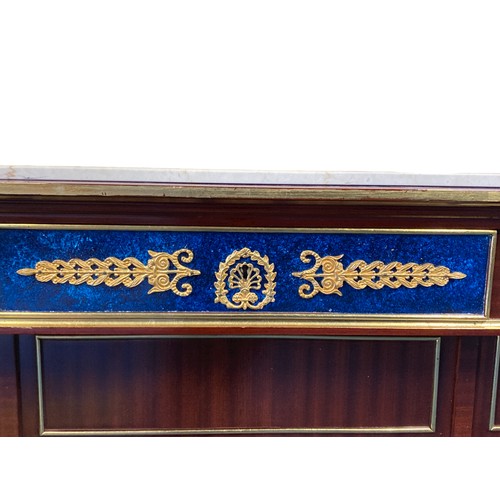 212 - A French Empire style Commode. With marble top, parcel-gilt and faux malachite drawer fronts.