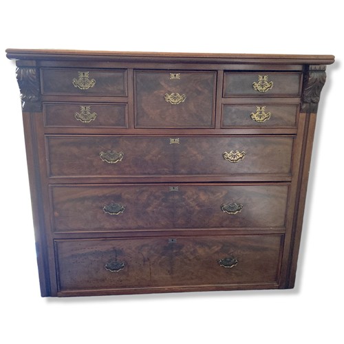 225 - A 19th-Century Mahogany Scotch Chest of Drawers. With carved finials. Square central drawer bordered... 