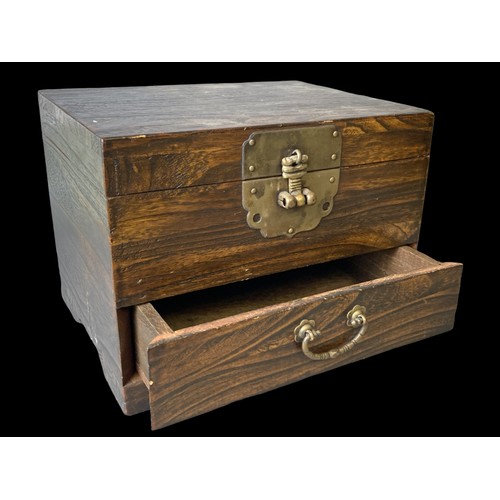 125 - A Chinese wooden Money box. Fitted with brass lock and handle.Comprises hinged lid and drawer below.... 