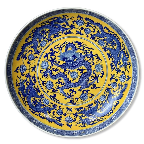 186 - Large Chinese Famille Jaune porcelain charger. Hand painted with a 5-claw Dragon amongst blossoming ... 