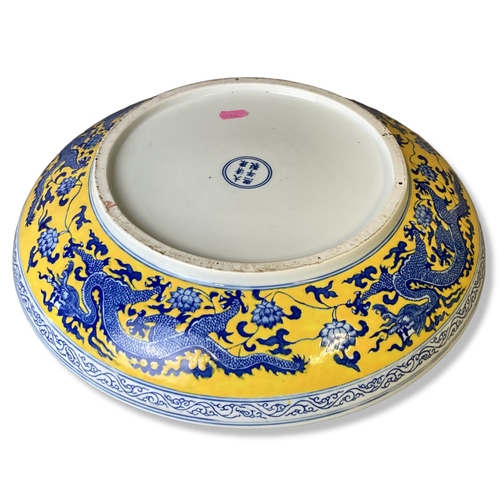 186 - Large Chinese Famille Jaune porcelain charger. Hand painted with a 5-claw Dragon amongst blossoming ... 