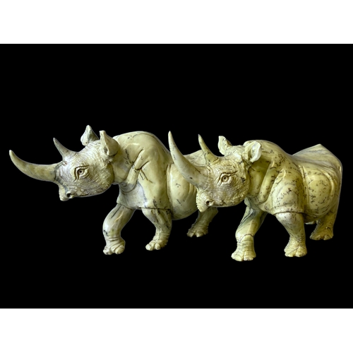 113B - A large pair of Zimbabwean (Shona) Butterjade Rhino carved stone sculptures. 
15 x 30cm